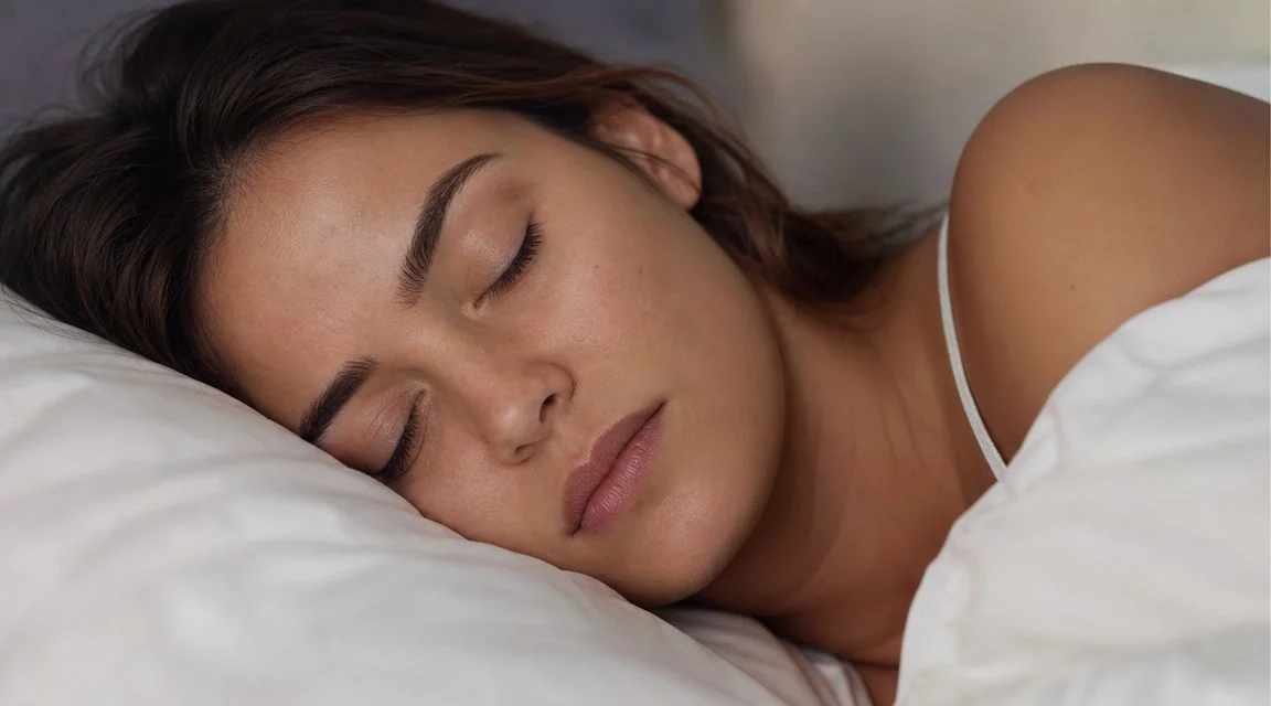 A young woman peacefully sleeping on a white pillow, emphasizing the importance of dental health during sleep.